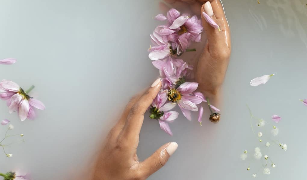 woman holding flowers in hands in water