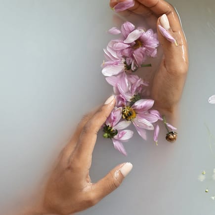 woman holding flowers in hands in water
