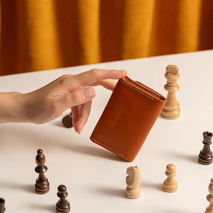 hand of a woman holding a leather purse
