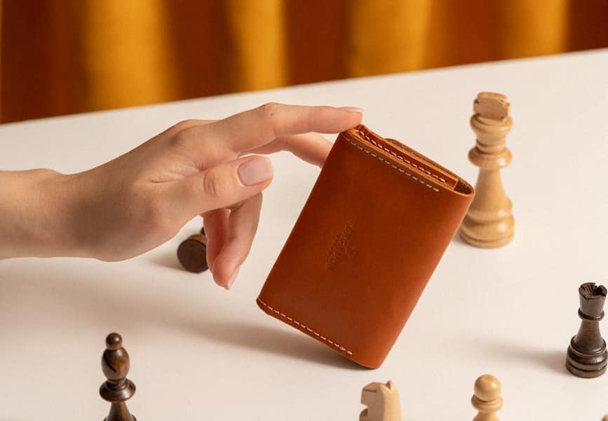 hand of a woman holding a leather purse